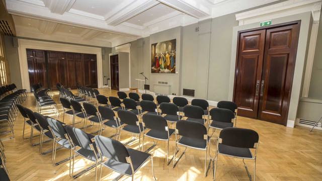 Empty Kevin Barry Recital Room with black chairs set for an event